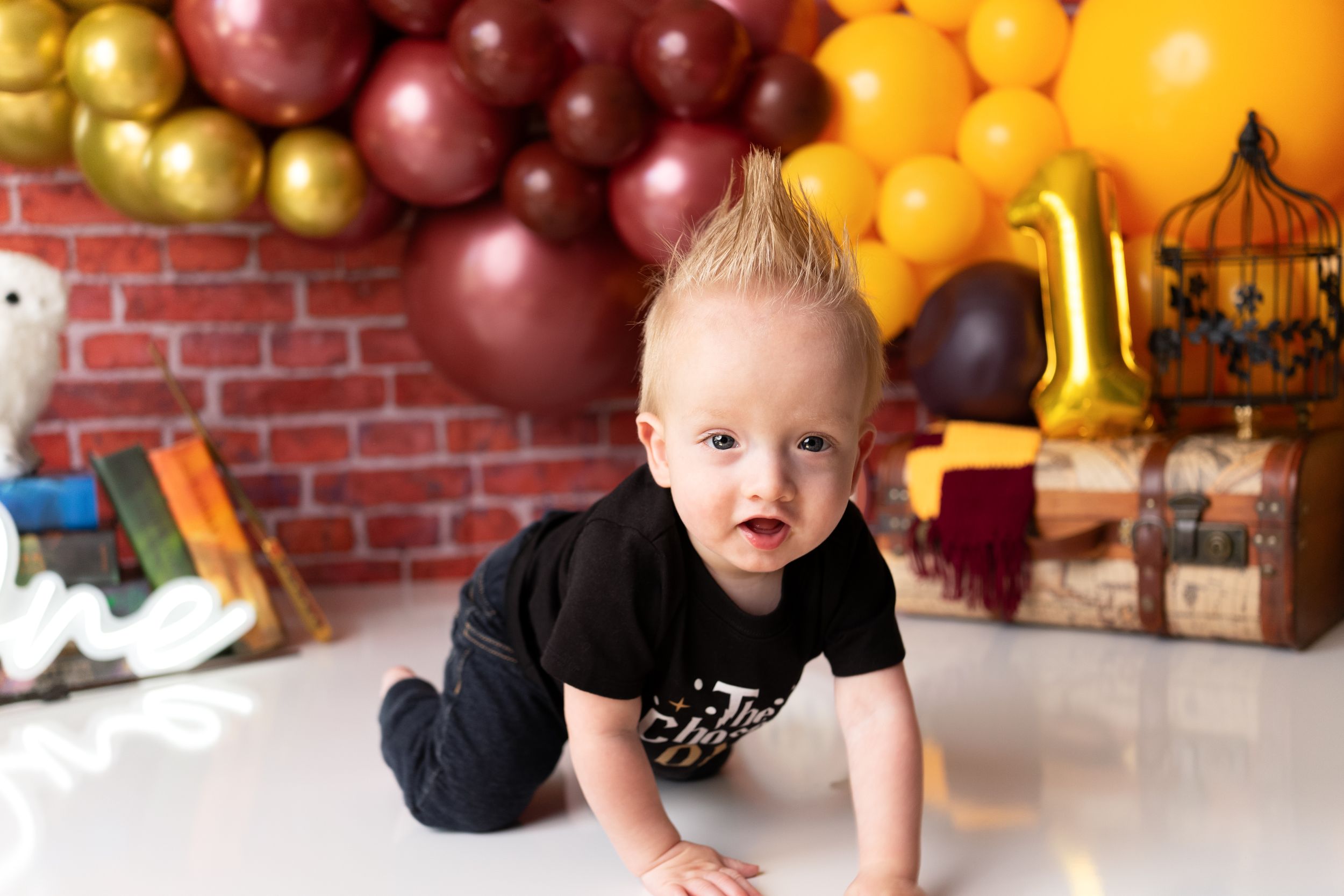 Child enjoying Harry Potter themed birthday party with magical decorations and balloons.