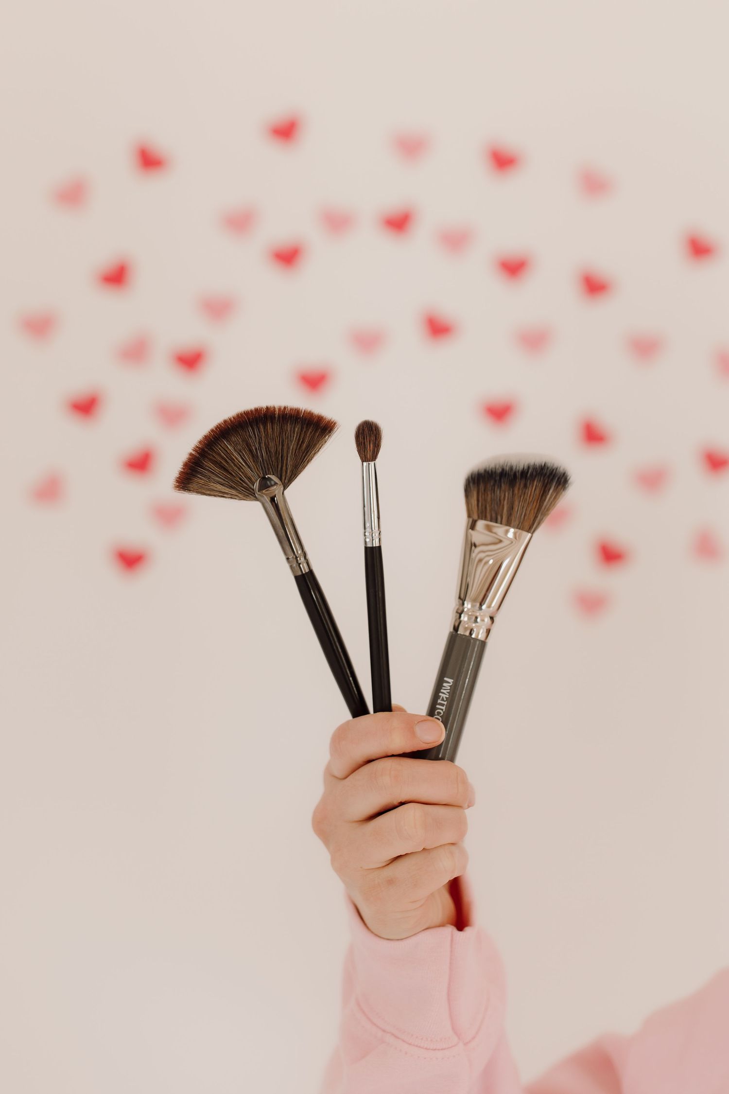 makeup brushes in hand of oklahoma city okc best makeup artist