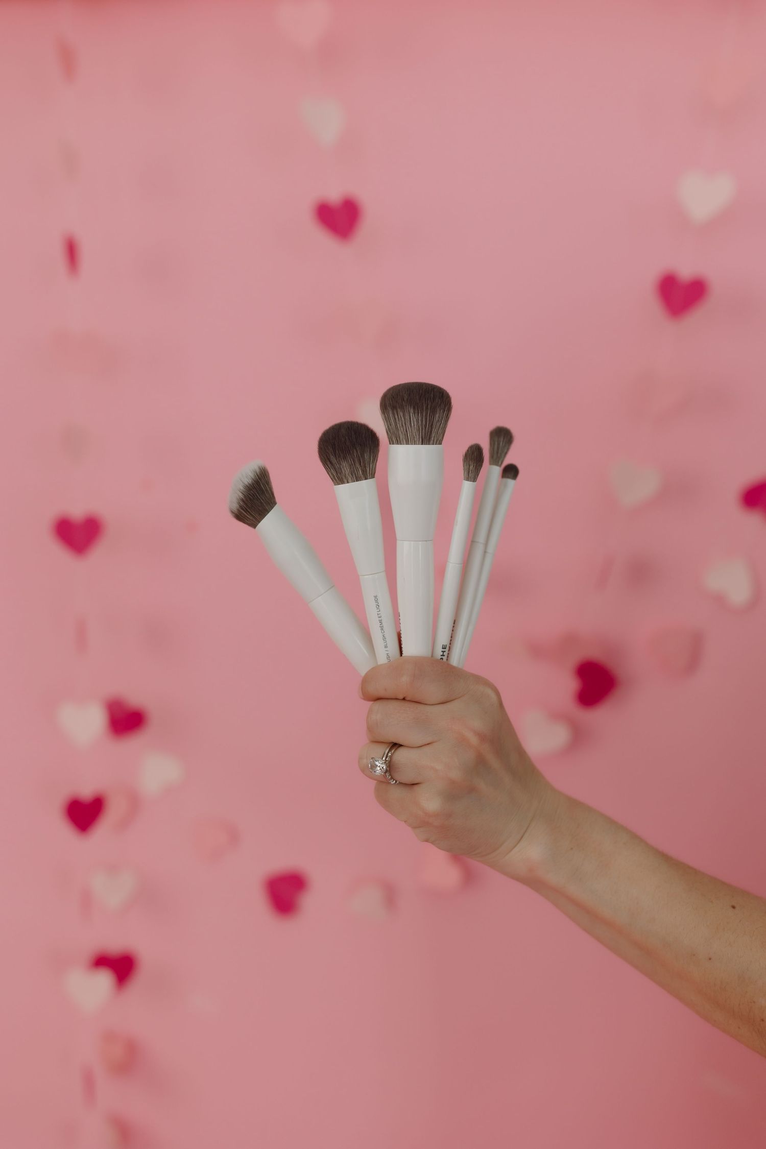 makeup brushes in hand of oklahoma city okc best makeup artist