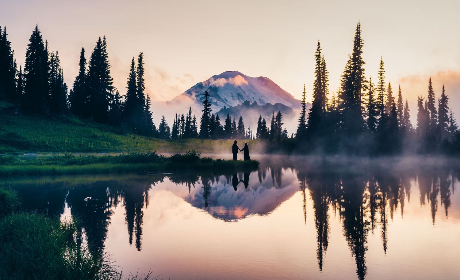 A couple at golden hour in beautiful Tipsoo Lake on Mt. Rainier, Washington.