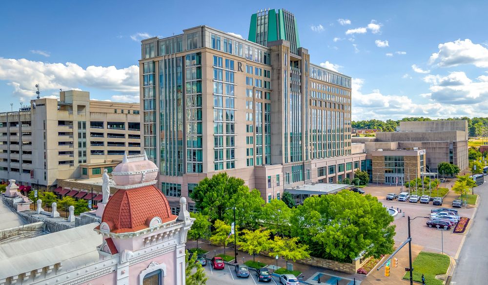 Downtown Durham streetscape featuring blend of historic and contemporary architecture with lush greenery.