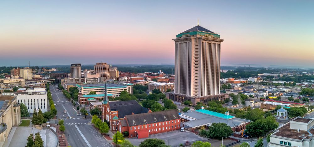 Downtown Montgomery skyline featuring tall hotel building and historic architecture along main street.