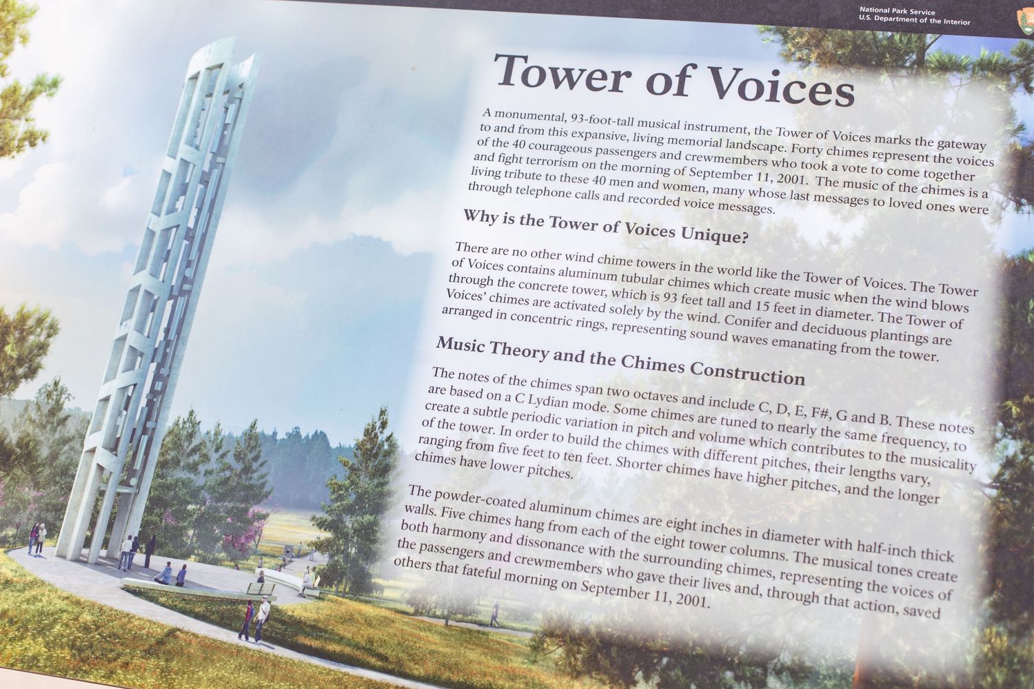Book pages showing text about the Tower of Voices memorial site with scenic landscape images.