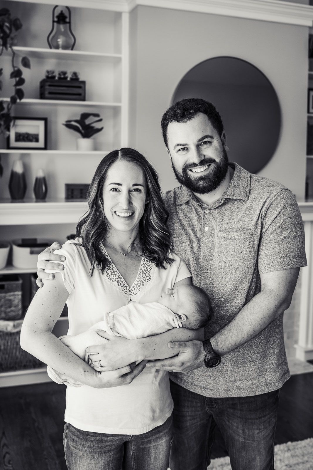 Family photo with newborn in their living room.