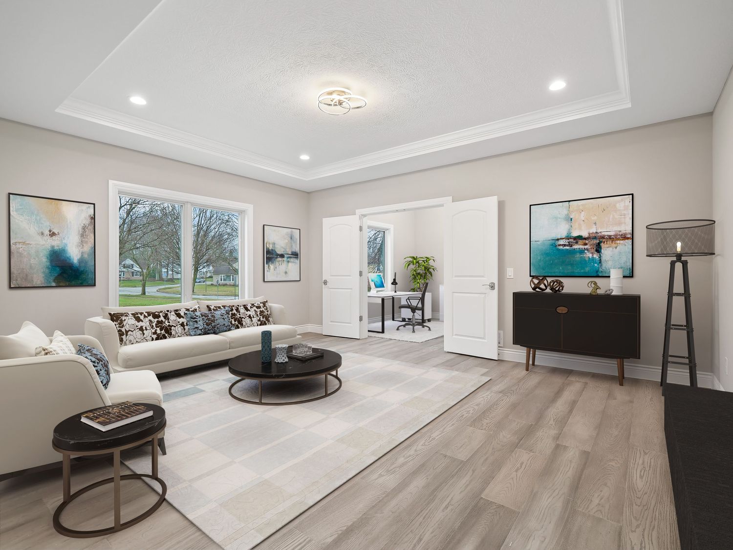 Modern living room with contemporary furniture, art pieces, and large windows with nature views.