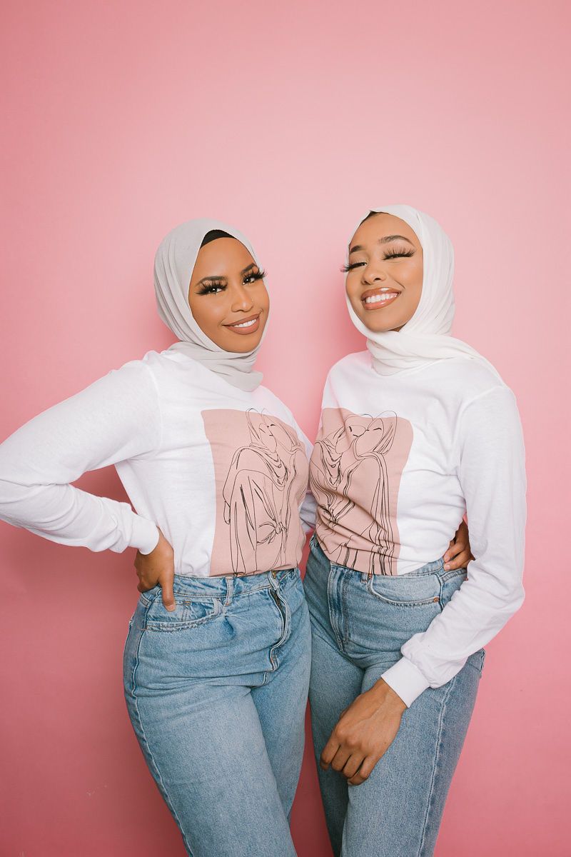 two hijabi women posing for the photo wearing the shirt from flaunt it's collection