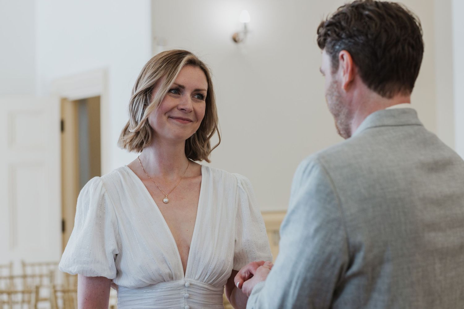 couple looking at each other and smiling exchanging their vows at Brighton Town Hall