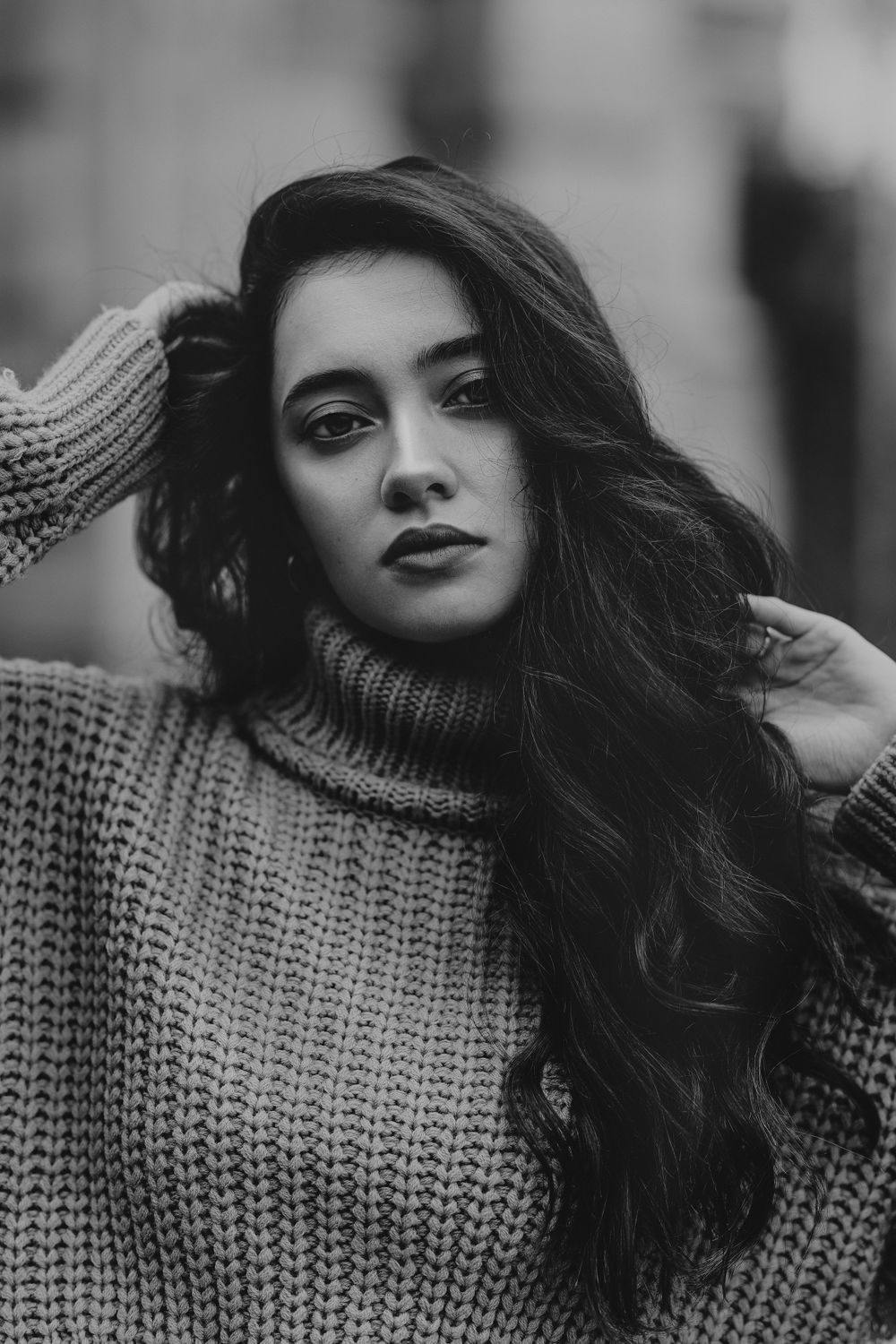 Dramatic black and white portrait showcasing a chunky turtleneck sweater and dark lipstick.