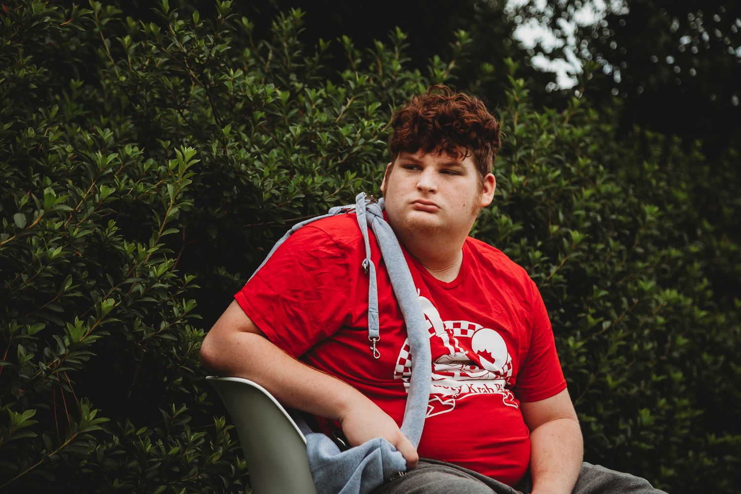 Young person in red shirt enjoying outdoor activities.