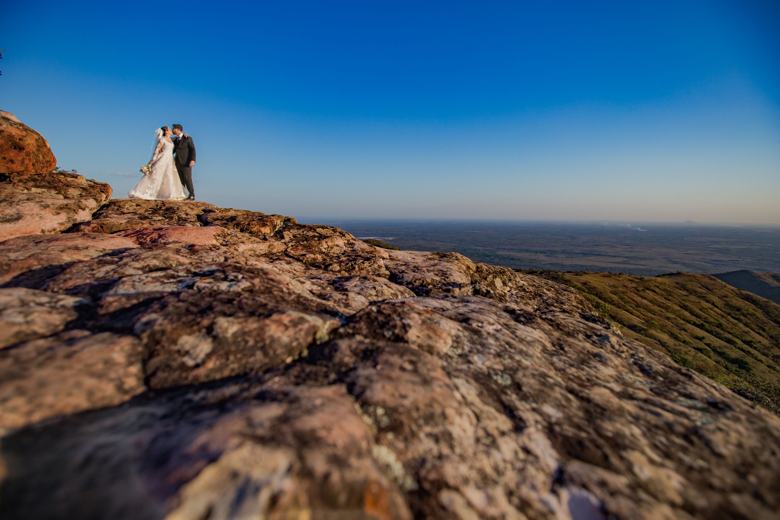 Panoramic mountain vista serves as backdrop for wedding photography session.