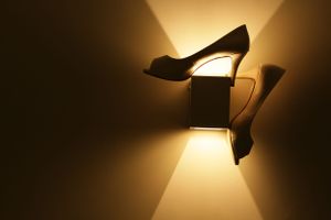 Dramatic lighting creates a warm glow through a window in a dark room.