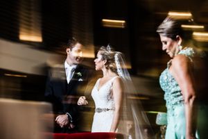 Candid emotional moment captured during indoor wedding ceremony.