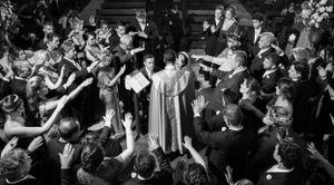 Black and white crowd shots show people dancing and celebrating at a party.