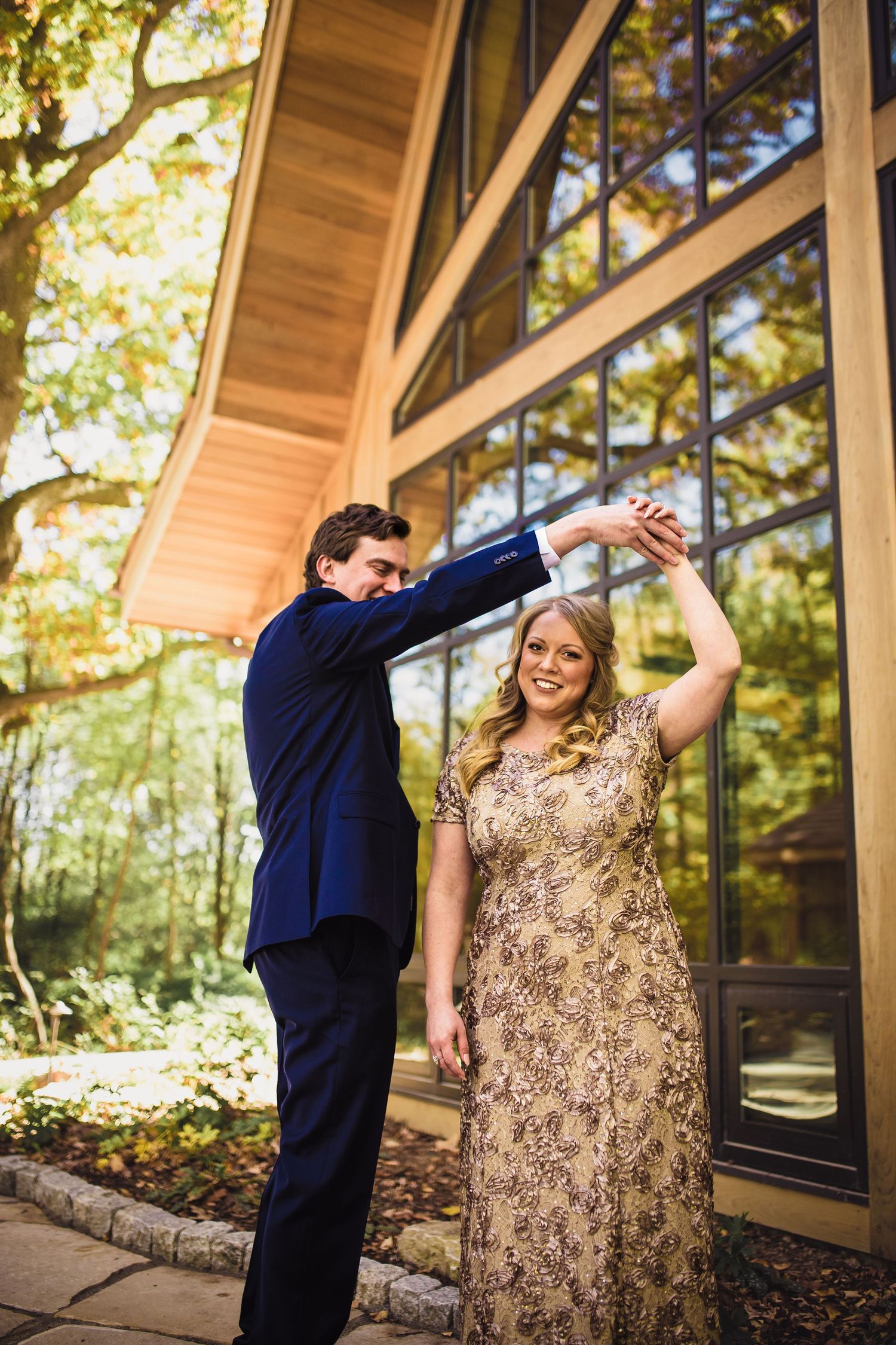 Bride and groom twirling in front of Milwaukee wedding venue
