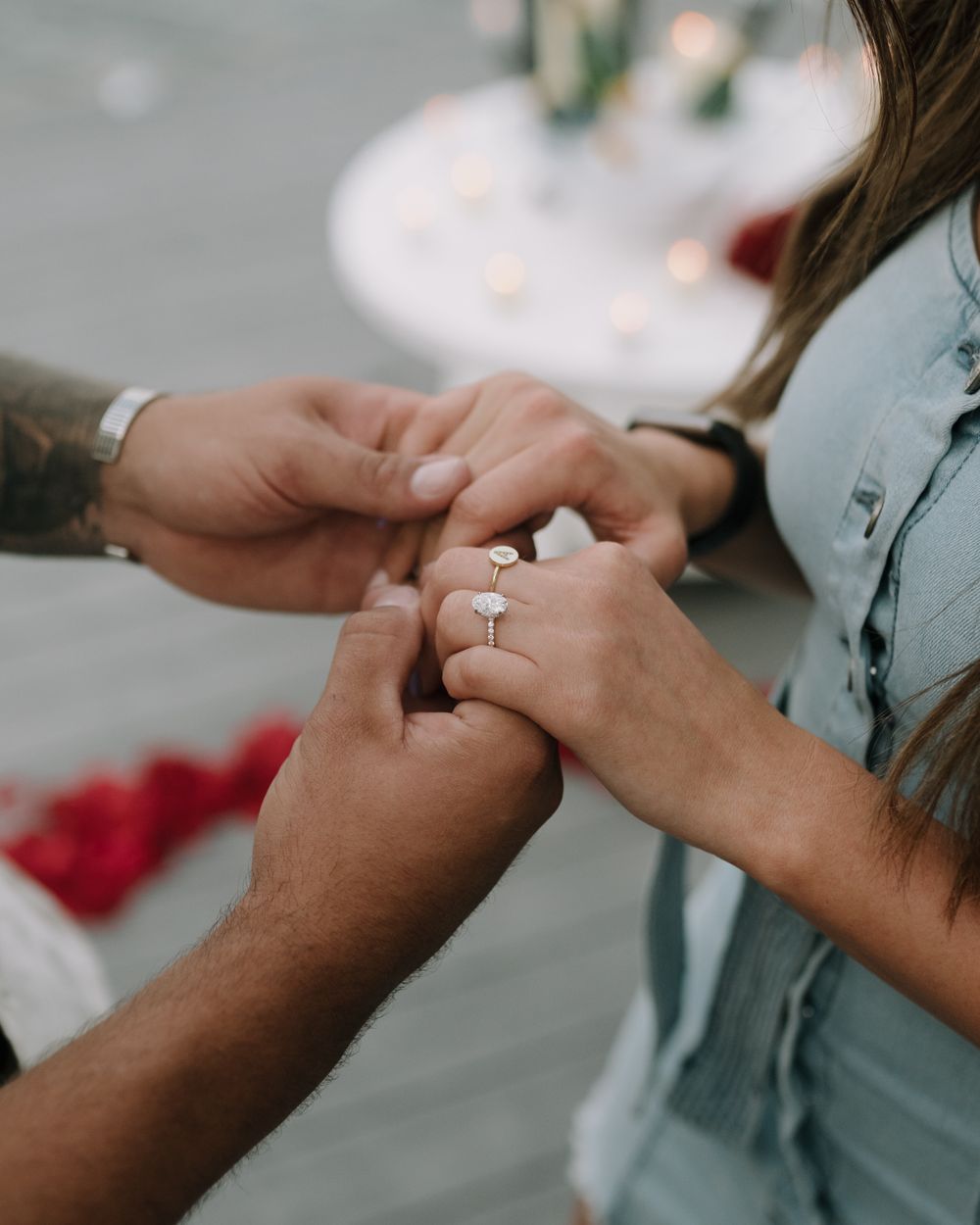 Close-up shot of hands displaying a new engagement ring.