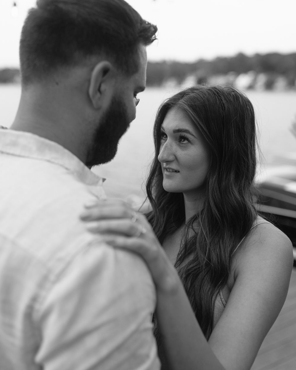 A couple shares joyful expressions during their engagement photography session.