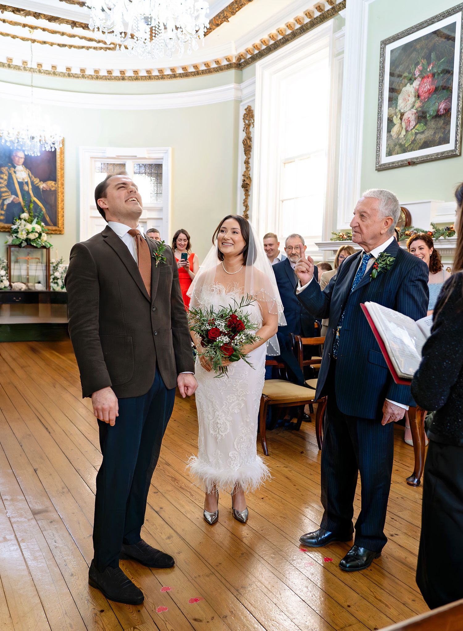 Dad is giving the bride away, and everybody is laughing. Location: Bournemouth.