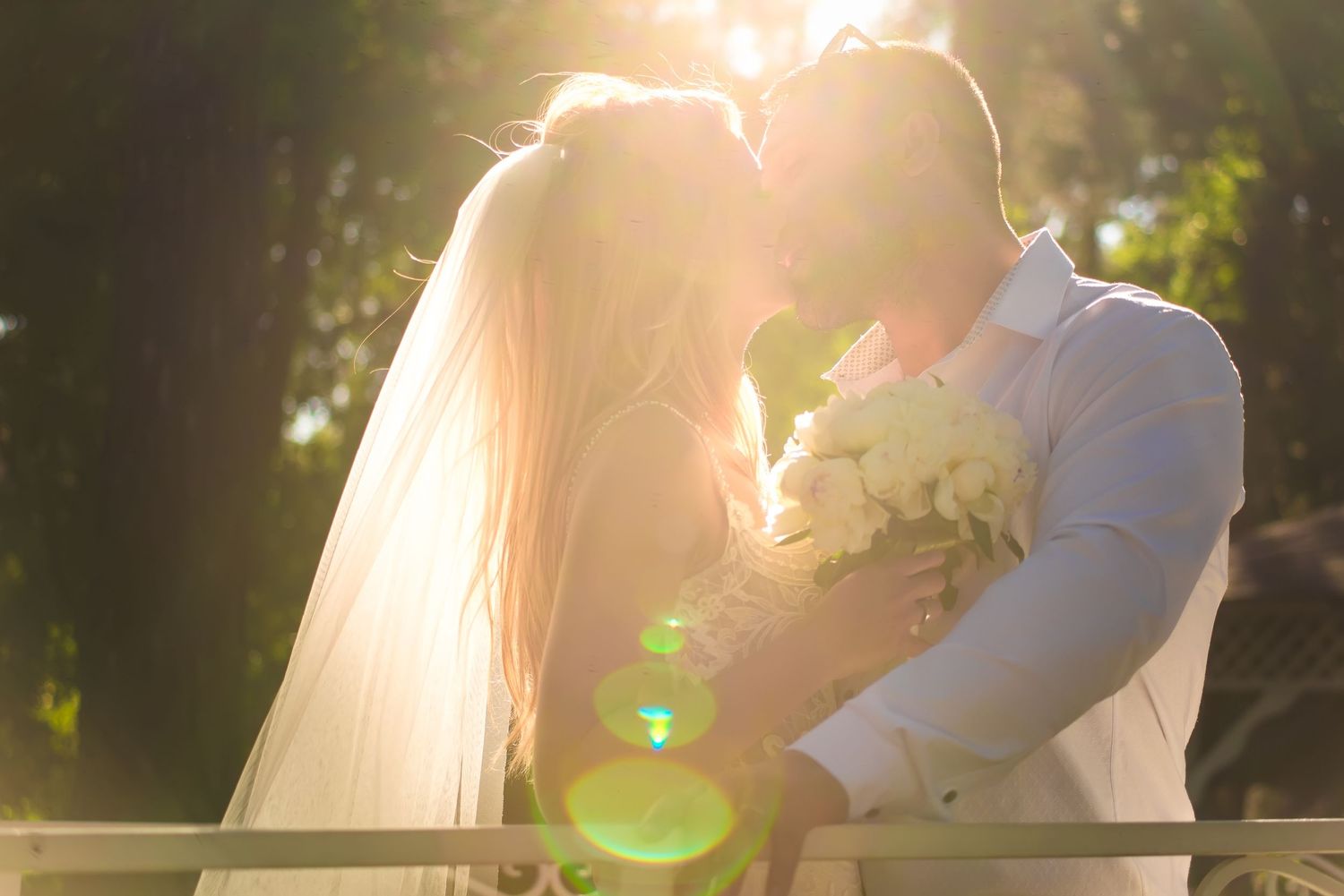 Romantic sunset wedding photography with soft golden light creating a dreamy atmosphere.