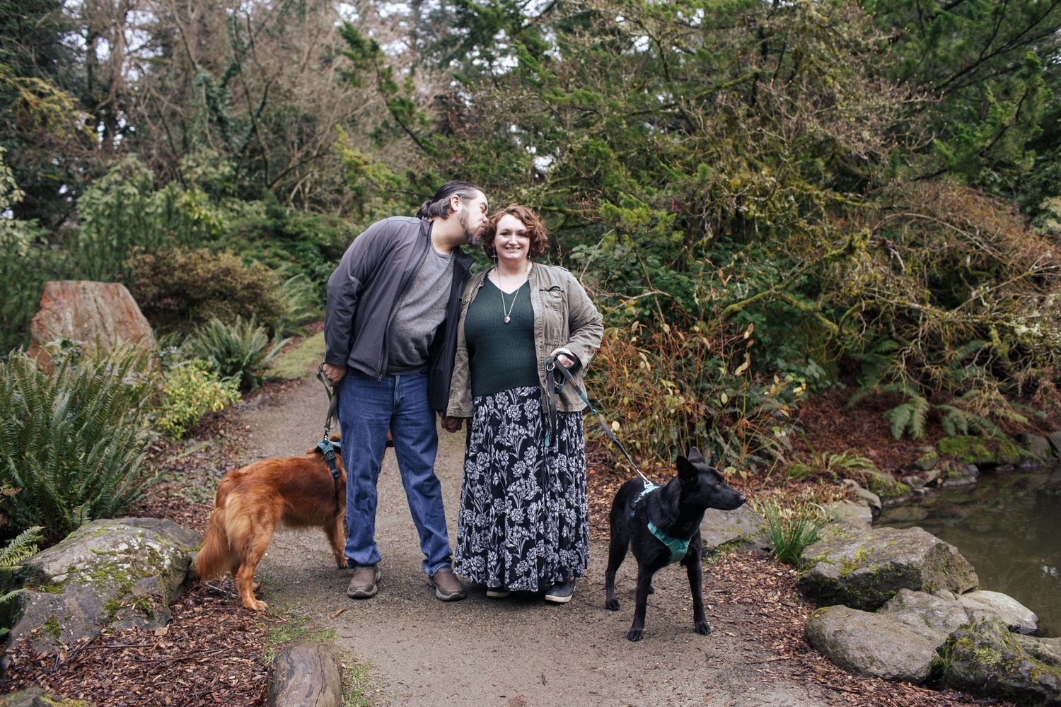 Seattle family photographer: a couple with their two dogs at a family photo session in Kubota Gardens Renton