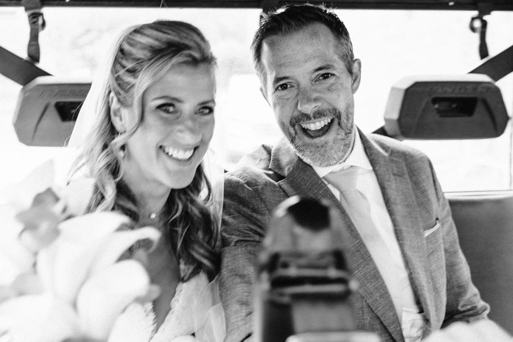 Wedding party smiling and laughing together during outdoor photo session.