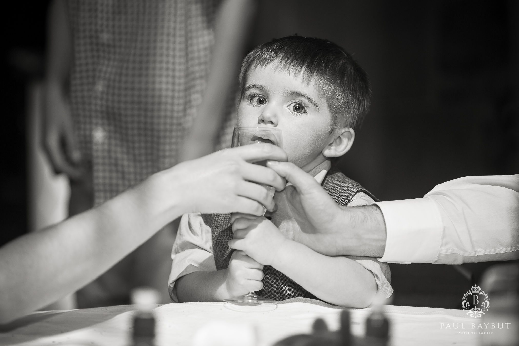A candid black and white moment captured during a meal or gathering.