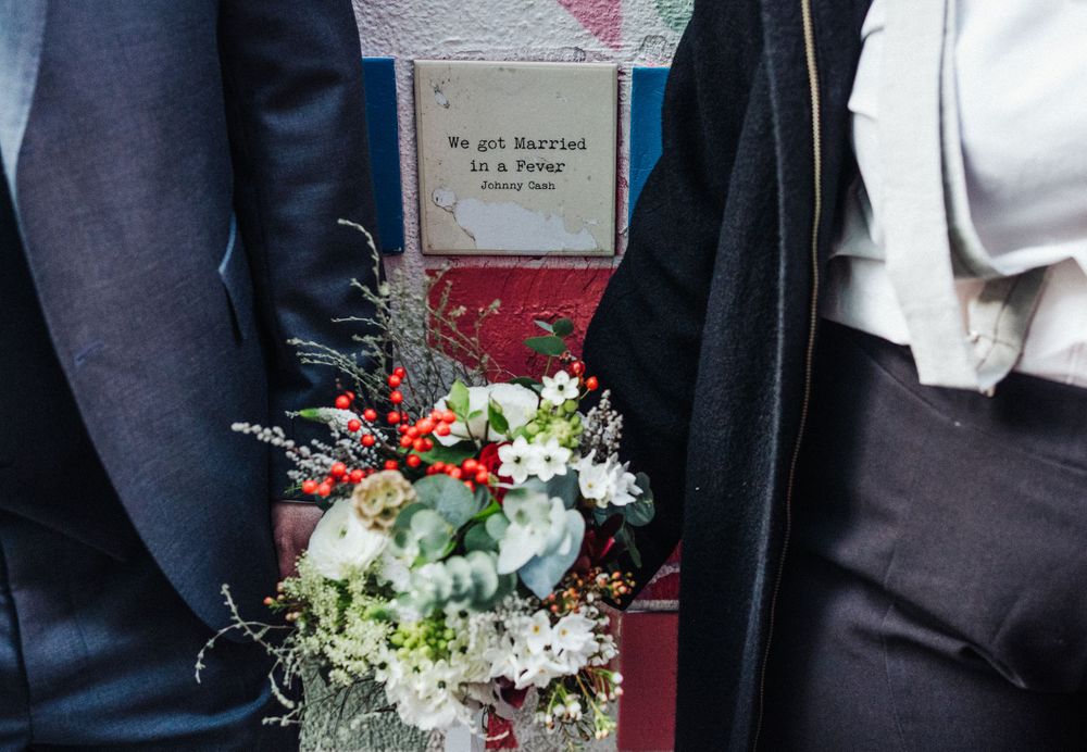 Close-up of an elegant wedding bouquet with white flowers and greenery.