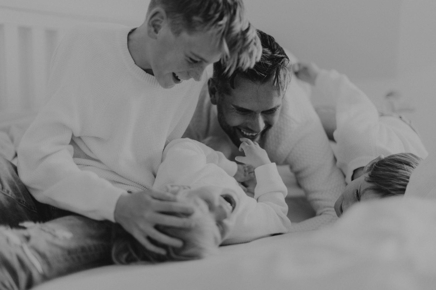 Black and white intimate portrait of a tender family moment.