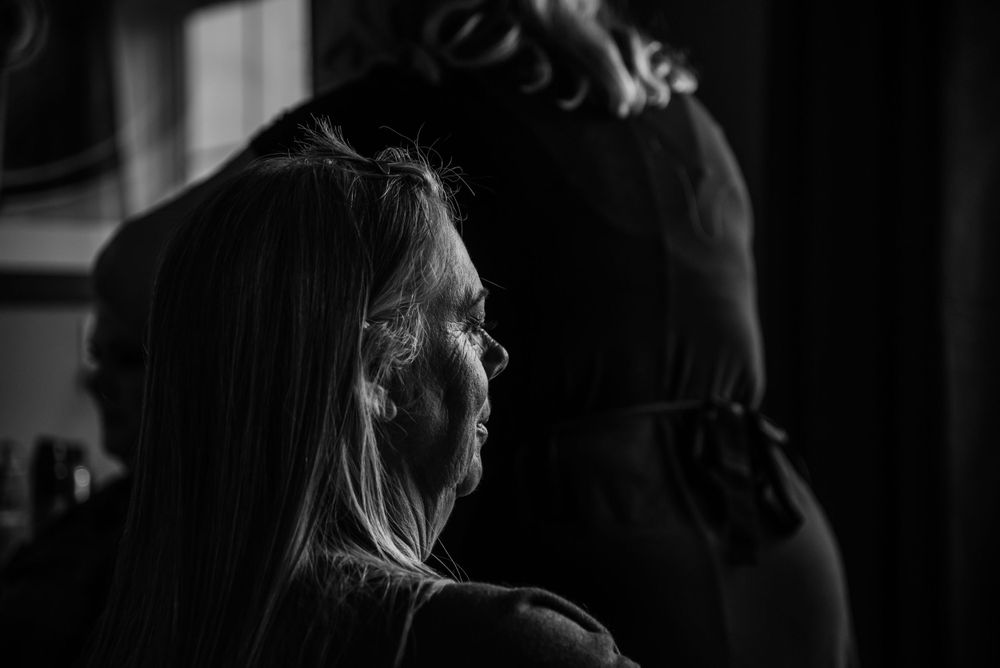 Black and white profile silhouette in dramatic side lighting.
