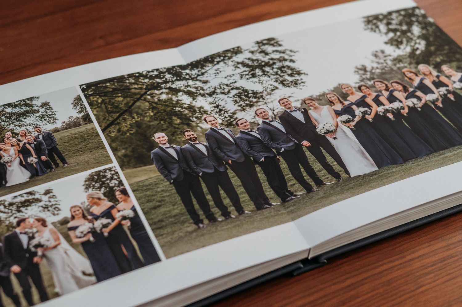 A wedding album spread showing traditional wedding party photos with bridesmaids in navy and groomsmen in suits outdoors.