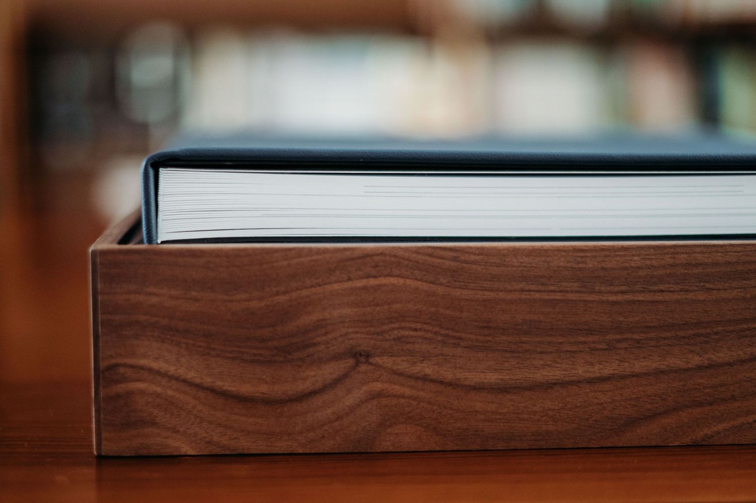 Close-up view of a brown wooden box or container with a book visible at the top.
