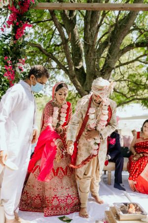 Traditional wedding ceremony with floral decorations and customary rituals.