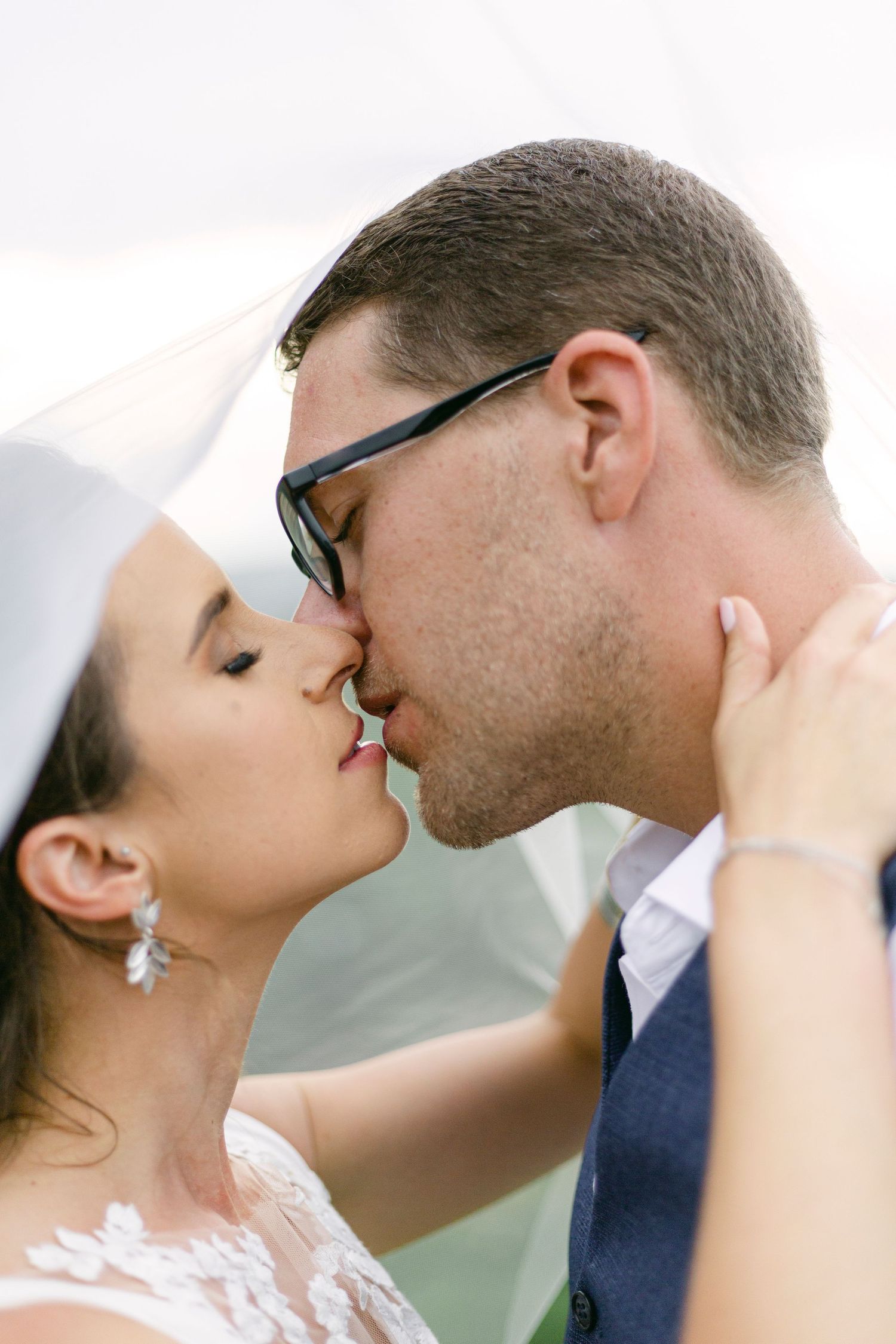 Couple kissing under veil