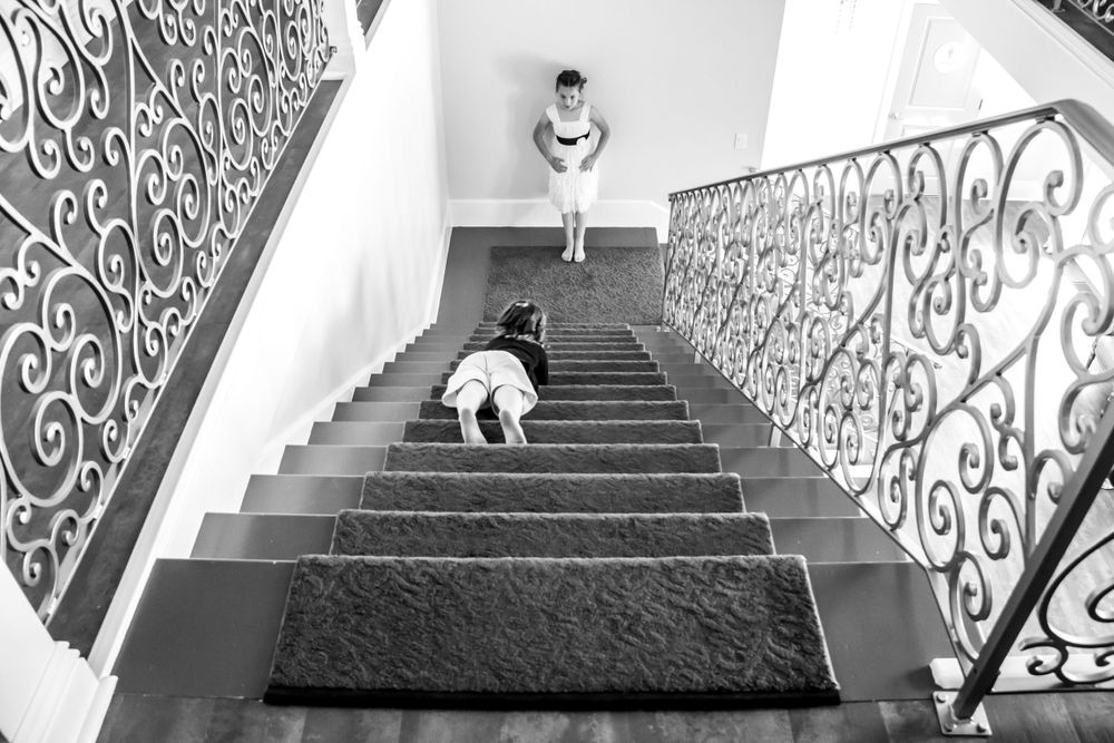 Ornate wrought iron stair railings with decorative scrollwork create a dramatic black and white architectural composition.