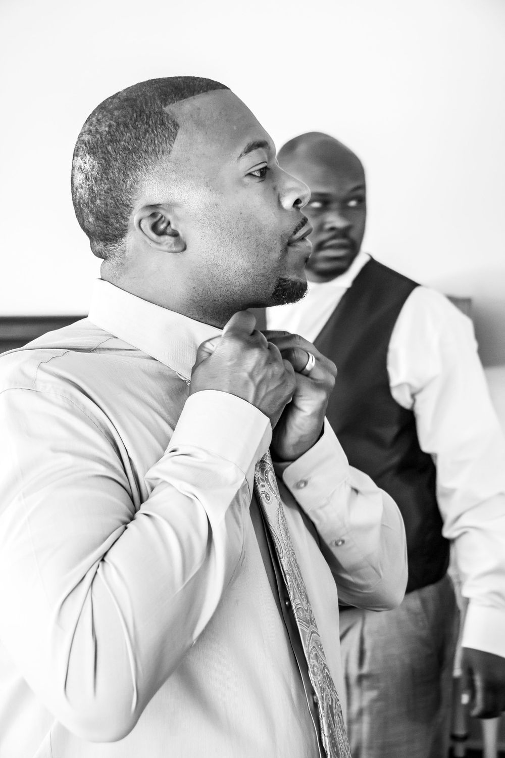 A sequence of black and white photos showing two people in white shirts having an animated conversation.