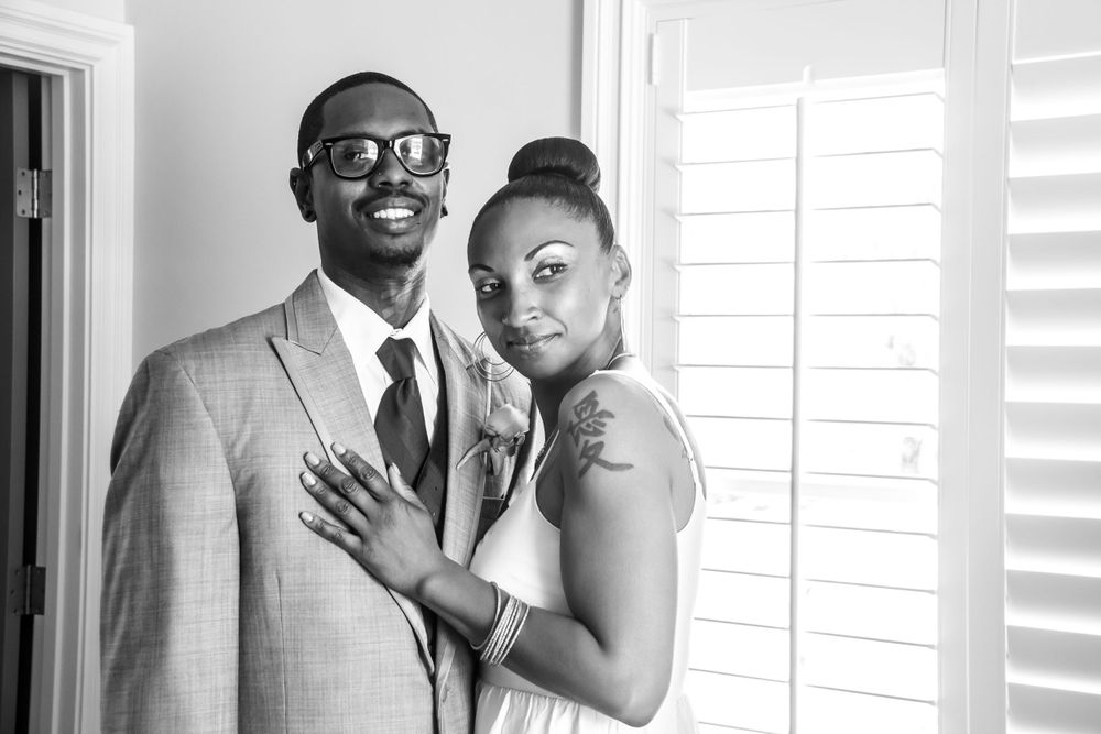 A series of four black and white photos showing a happy couple posing together on their wedding day.