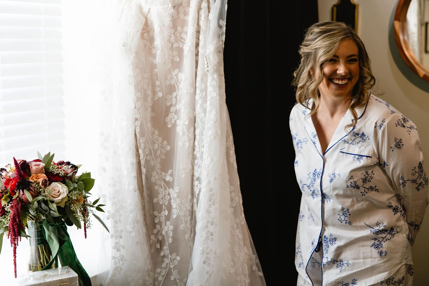Wedding dress details with lace and tulle hanging in natural light.
