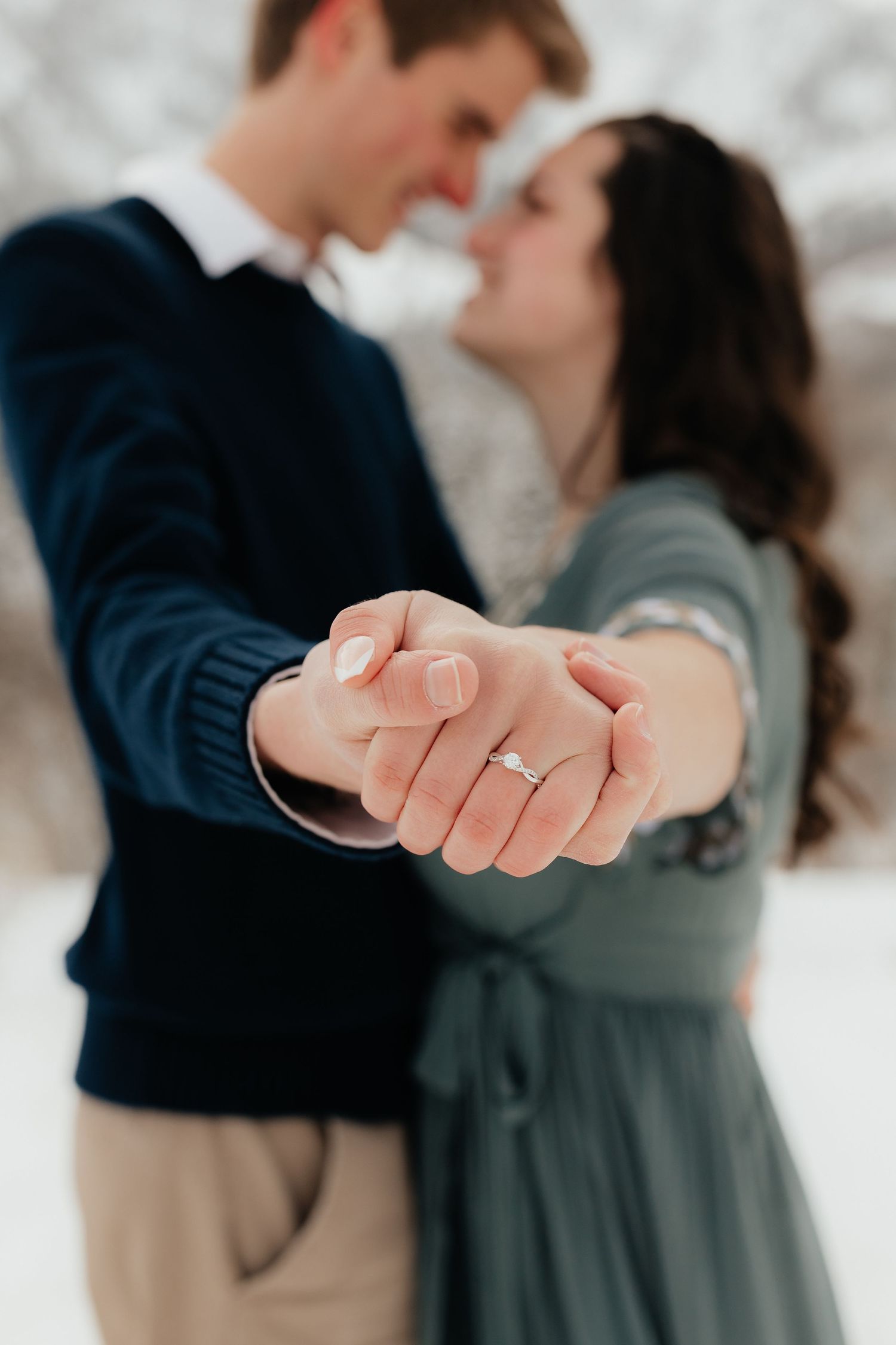 Engaged Couple showing Engagement Ring to Camera