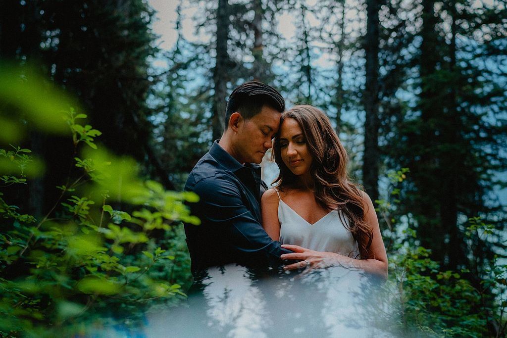 Romantic forest dance captured through green summer foliage.