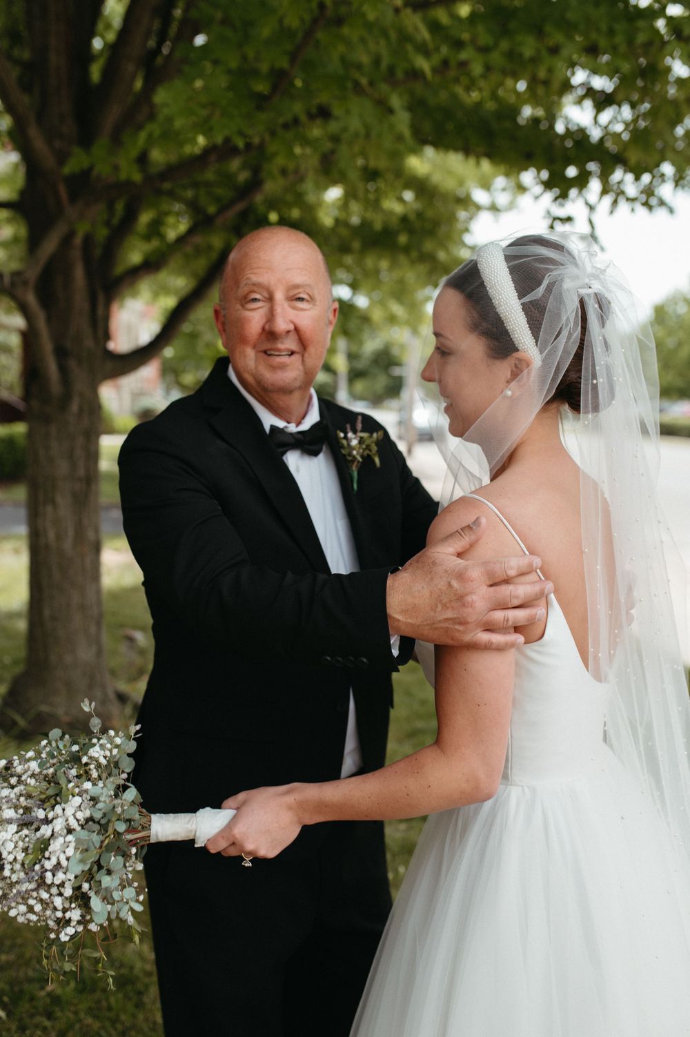 Tender moment captured between two people during an outdoor wedding ceremony.