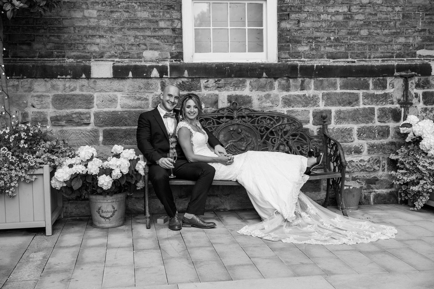 Bride & Groom sitting on bench at The West Mill Wedding Venue