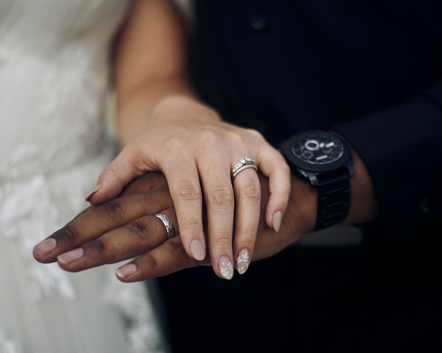 wedding rings on the bride and grooms hands