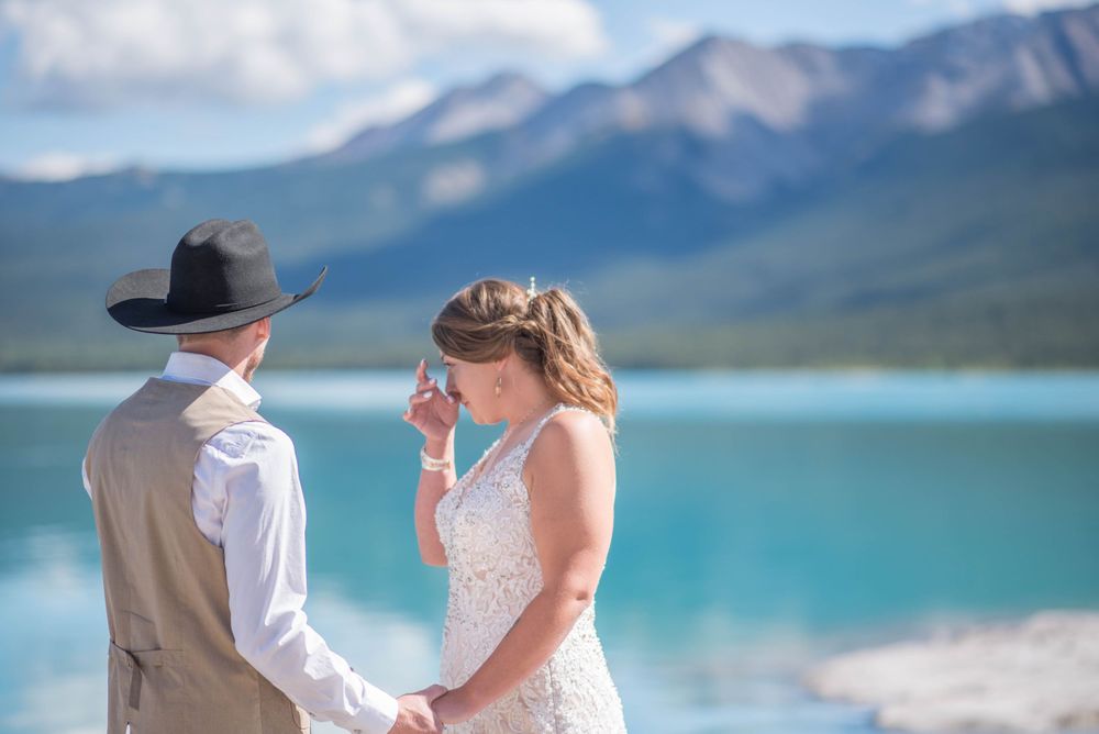 An intimate mountain wedding ceremony with stunning turquoise lake and mountain views.