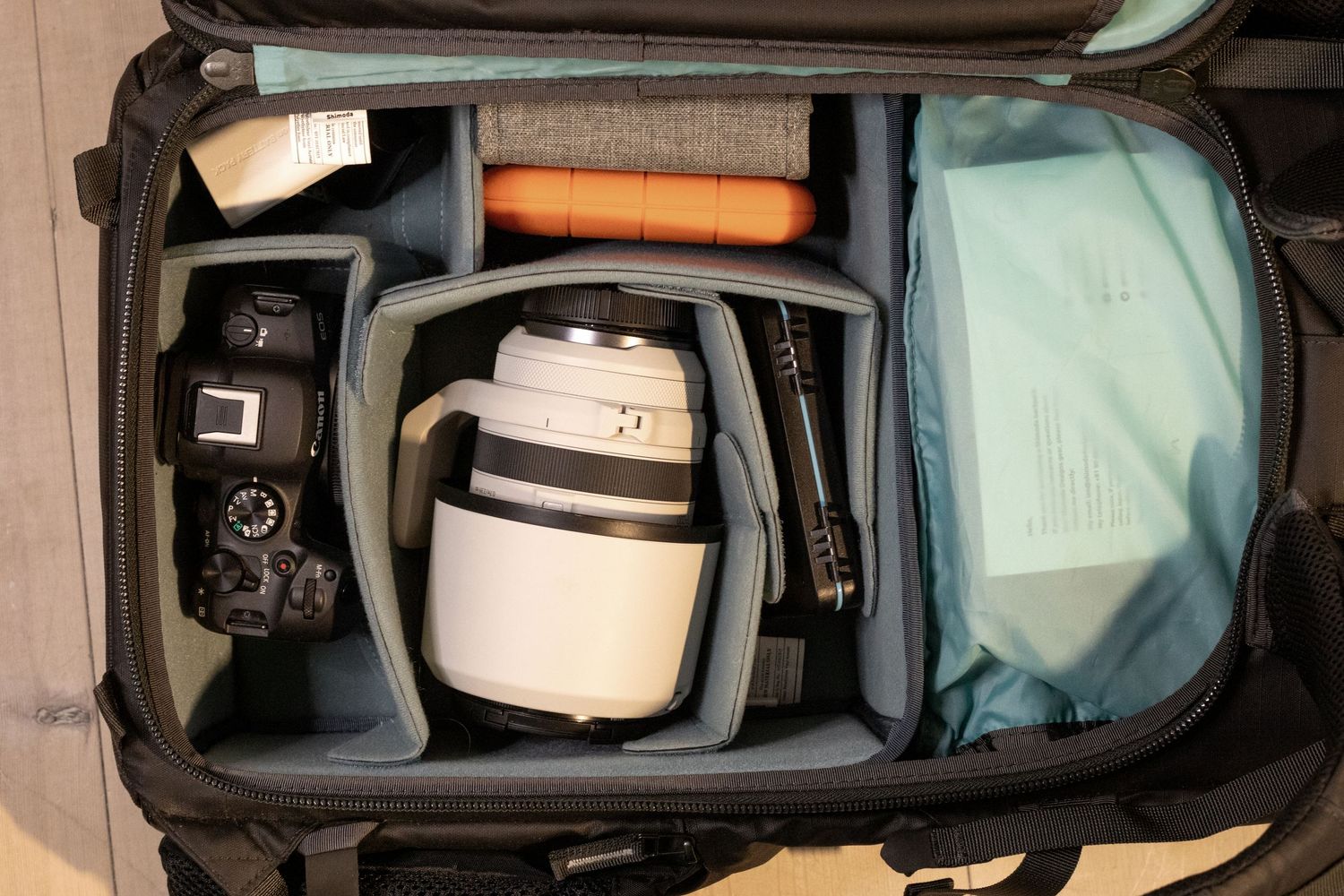 Organized camera bag showing professional photography gear and lenses neatly packed.