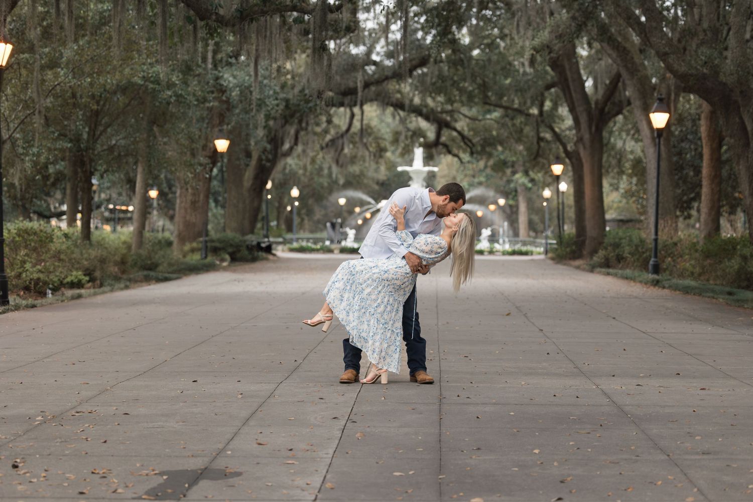 Tree-lined pathway with Spanish moss hanging from branches creating a romantic tunnel effect.