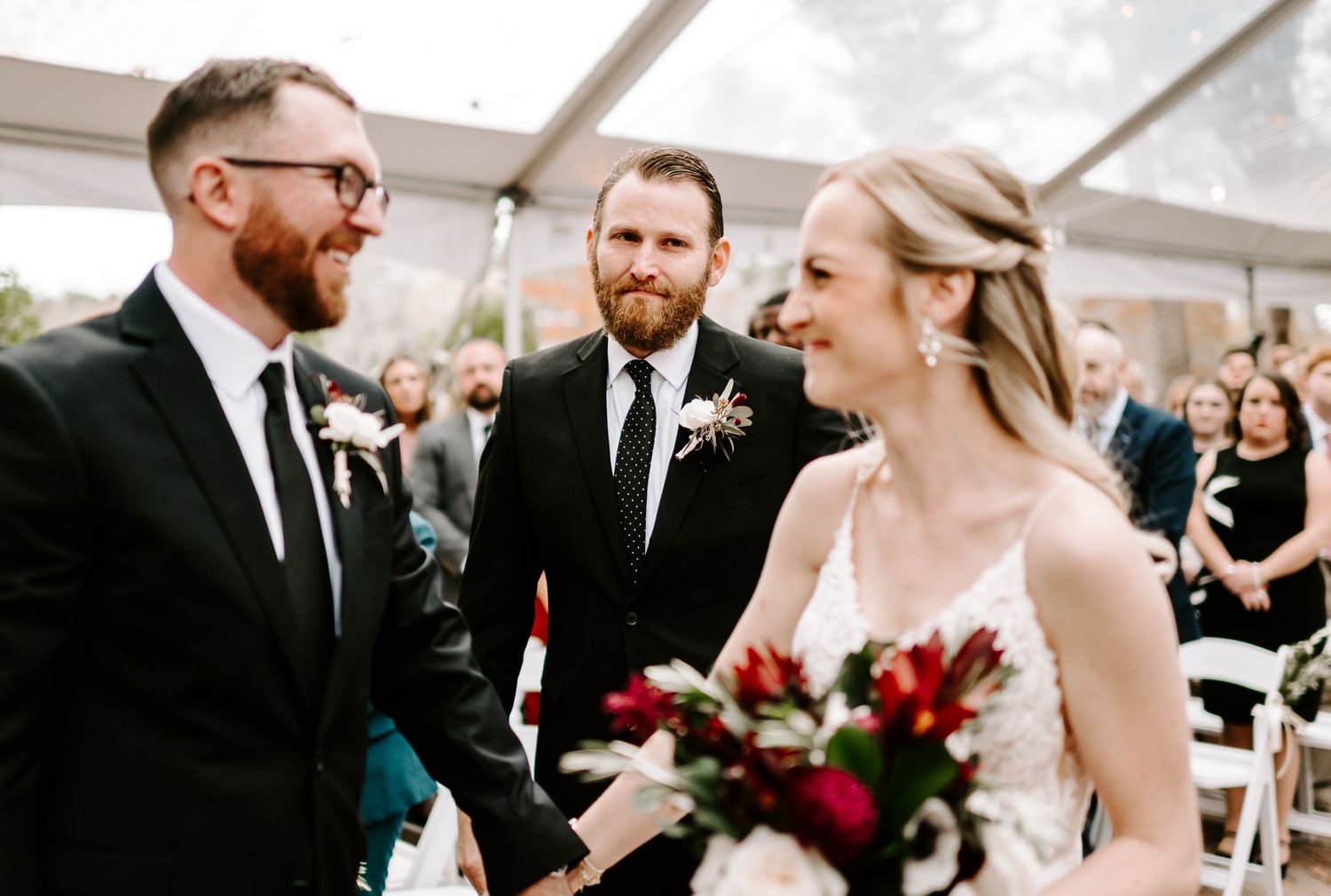 Wedding ceremony moments captured under a clear tent with elegant decor and floral arrangements.