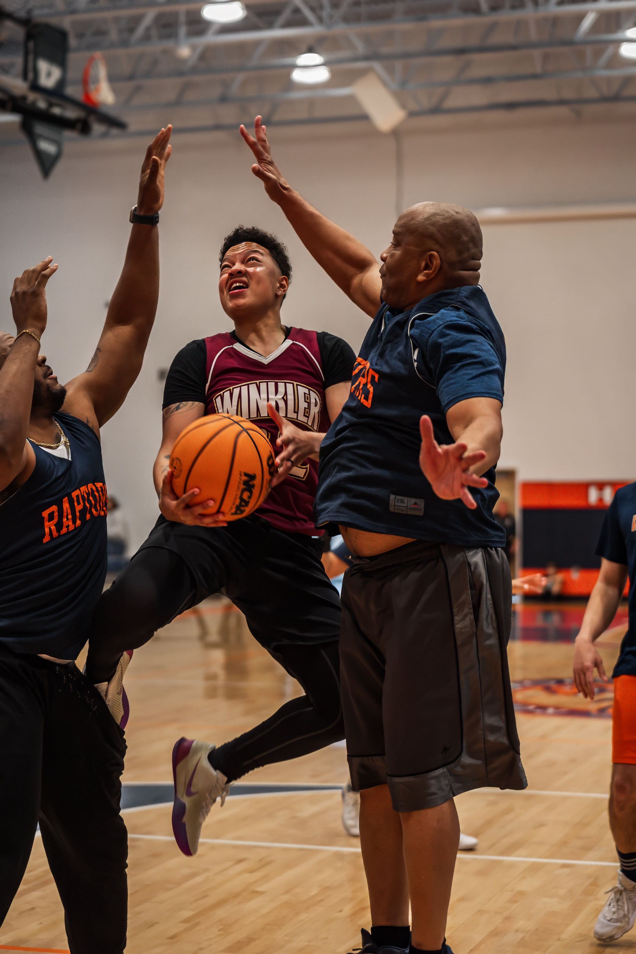 Intense basketball action as players compete for the ball during a game.