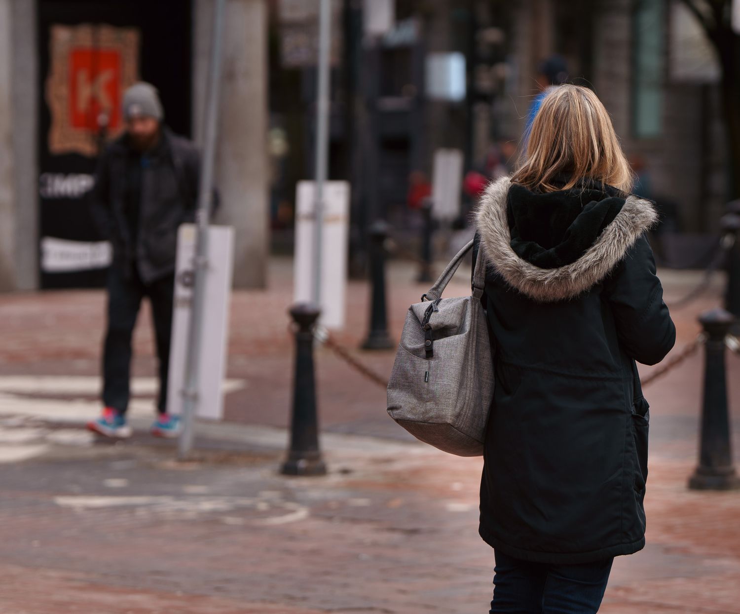 A woman lookingout in the distance, street photography.