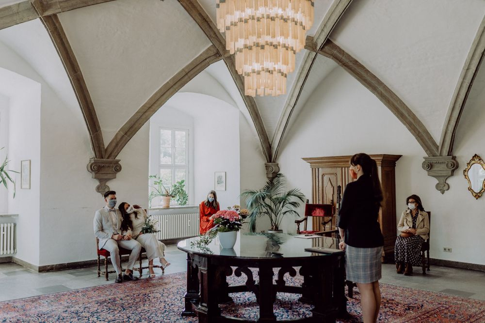 Elegant interior room with vaulted ceilings, crystal chandelier, and vintage furniture on a decorative rug.