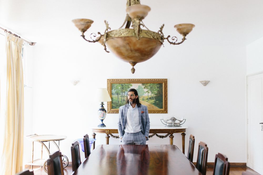 Elegant dining room interior with chandelier, antique furniture and landscape painting.