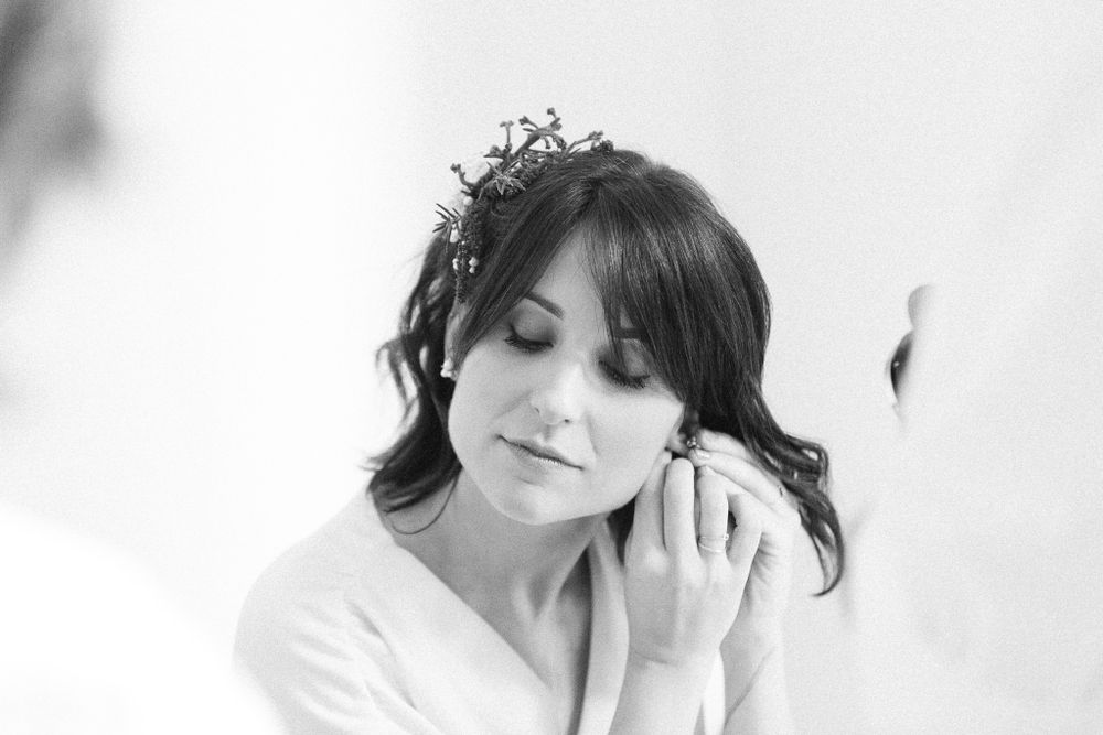 Elegant bridal portrait in black and white with floral hair piece.